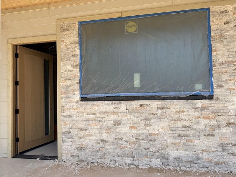 Completed stone exterior wall and entry door after renovation