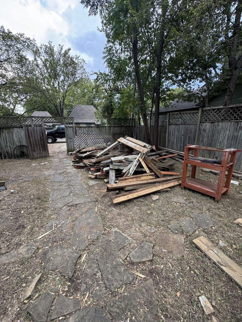 Backyard before deck construction, with demolition debris cleared