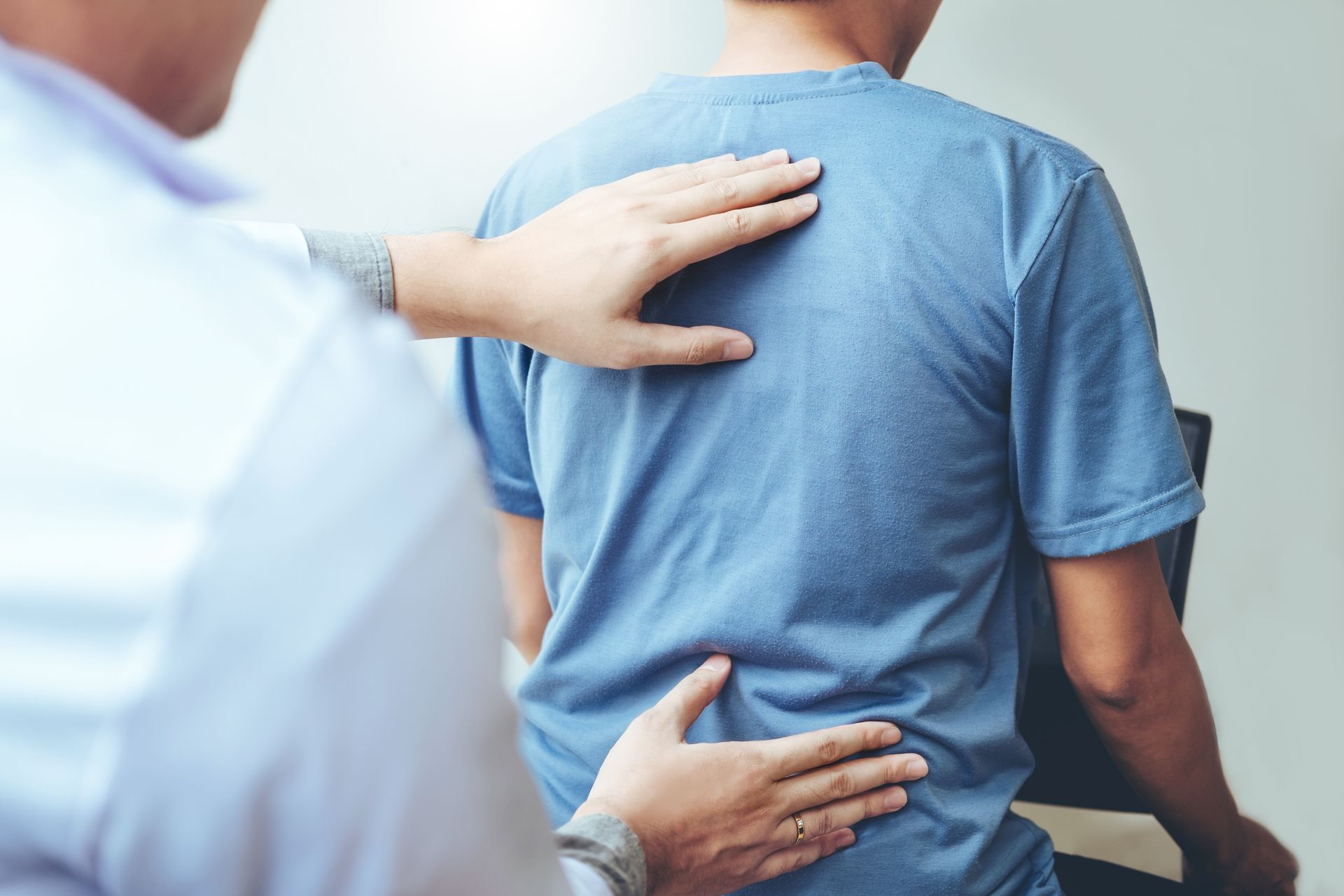 Doctor consulting with patient with back problems.