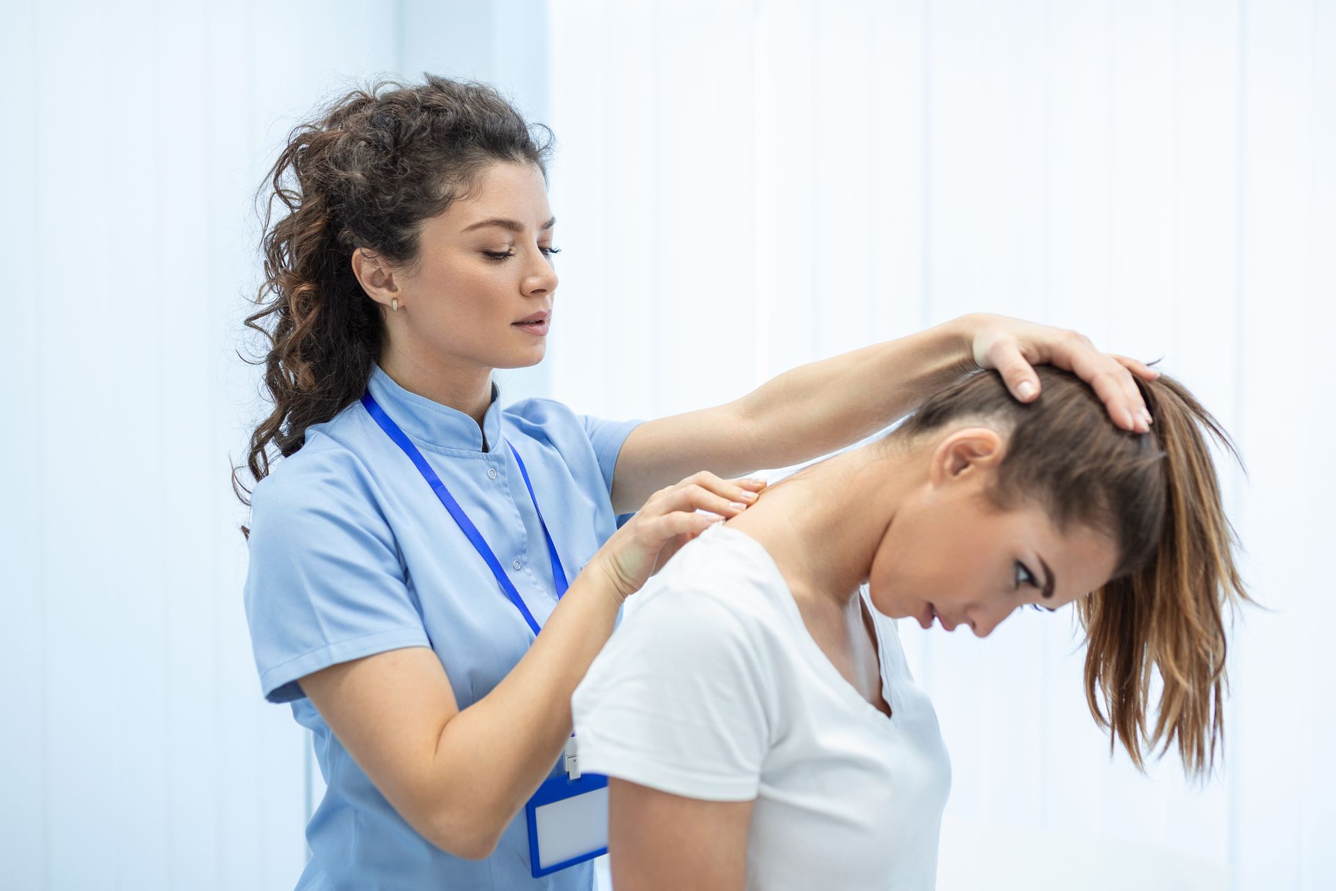 Healthcare professional performing manual therapy on a patient’s neck.