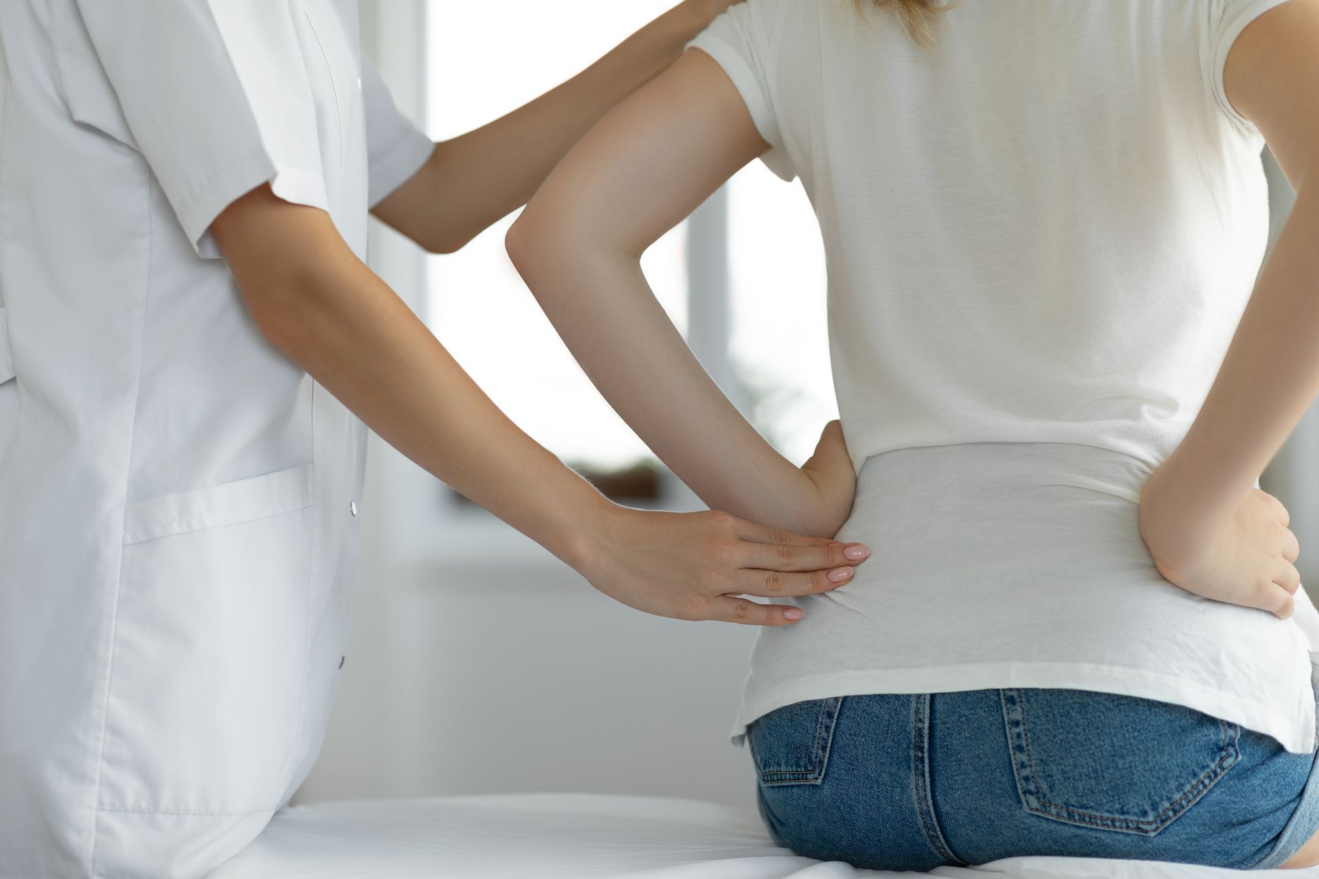 Woman suffering from low back during medical exam