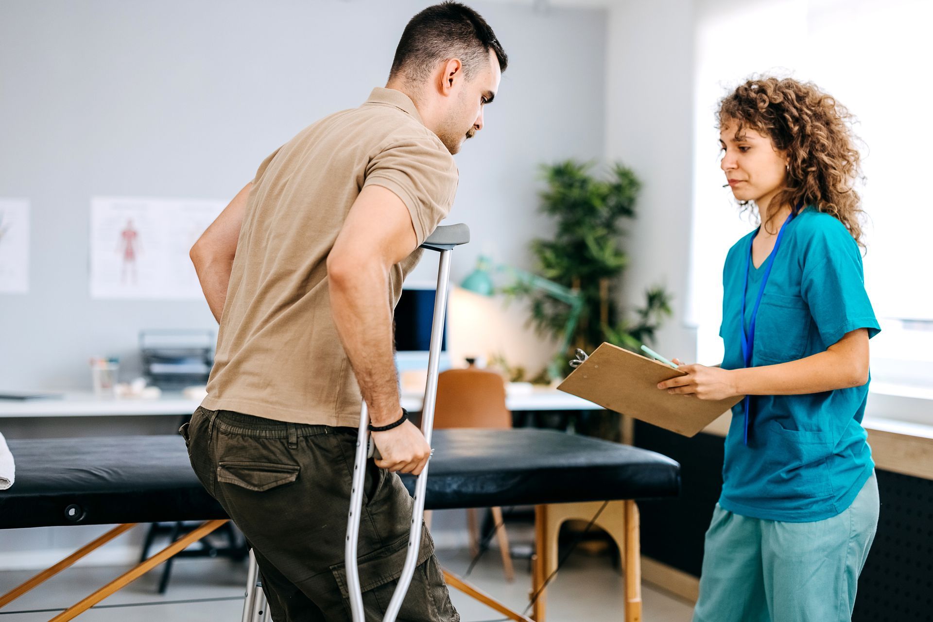 A man being examined by a physiotherapist at the clinic. A man being examined by a physiotherapist at the clinic.