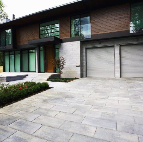 “Modern home exterior with smooth concrete pavers leading to the garage and entryway by a concrete contractor in Casas Adobes, AZ”