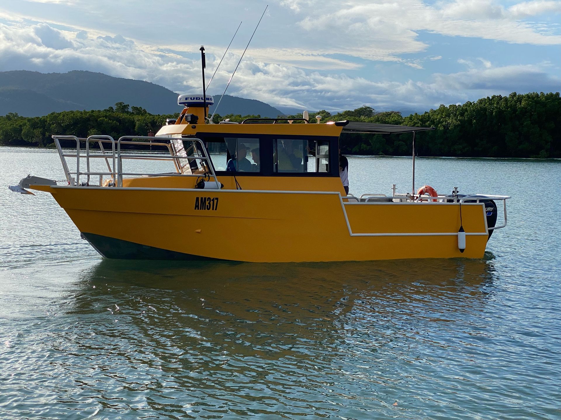A yellow boat with the letters mtc on the side