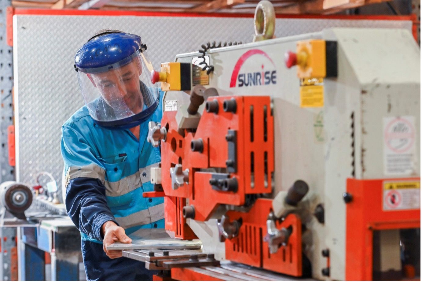 A man is working on a machine in a factory.