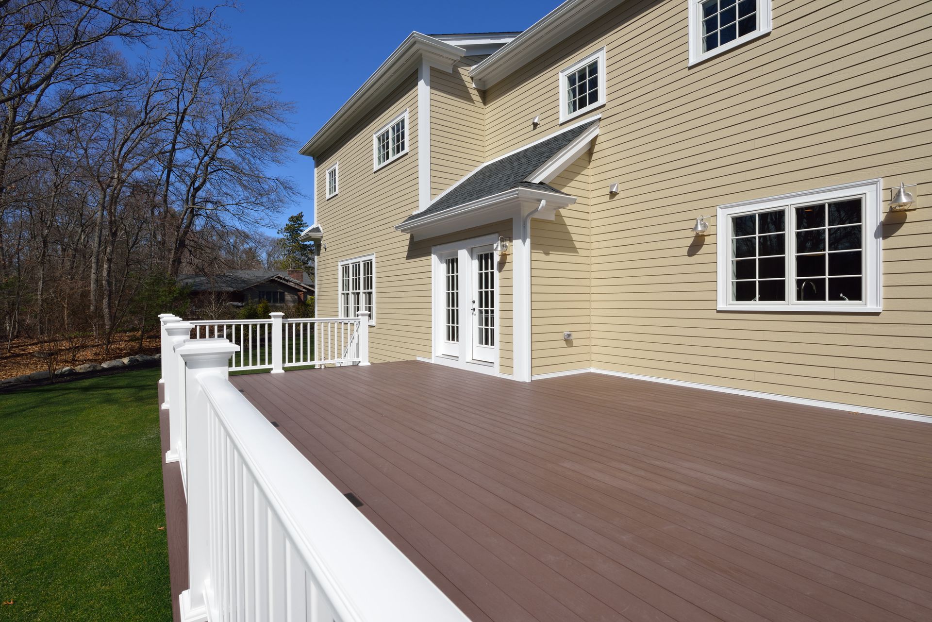 A large house with a large deck in front of it