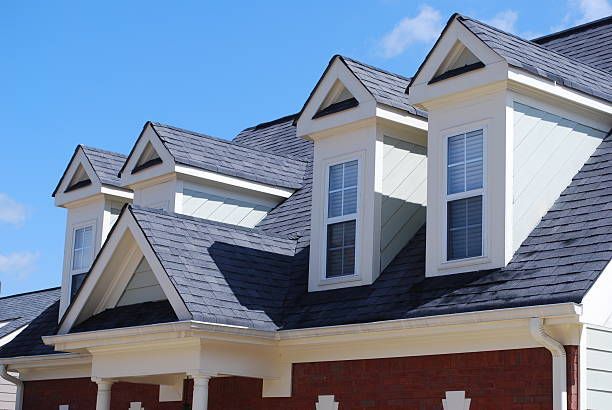 The roof of a house has a lot of windows on it
