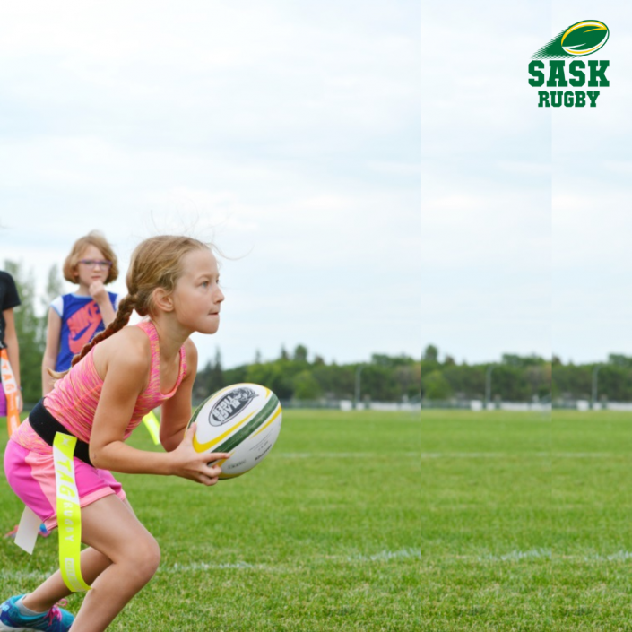 A young person in a pink athletic top holding a rugby ball on a grassy field, with a Sask Rugby logo in the corner.