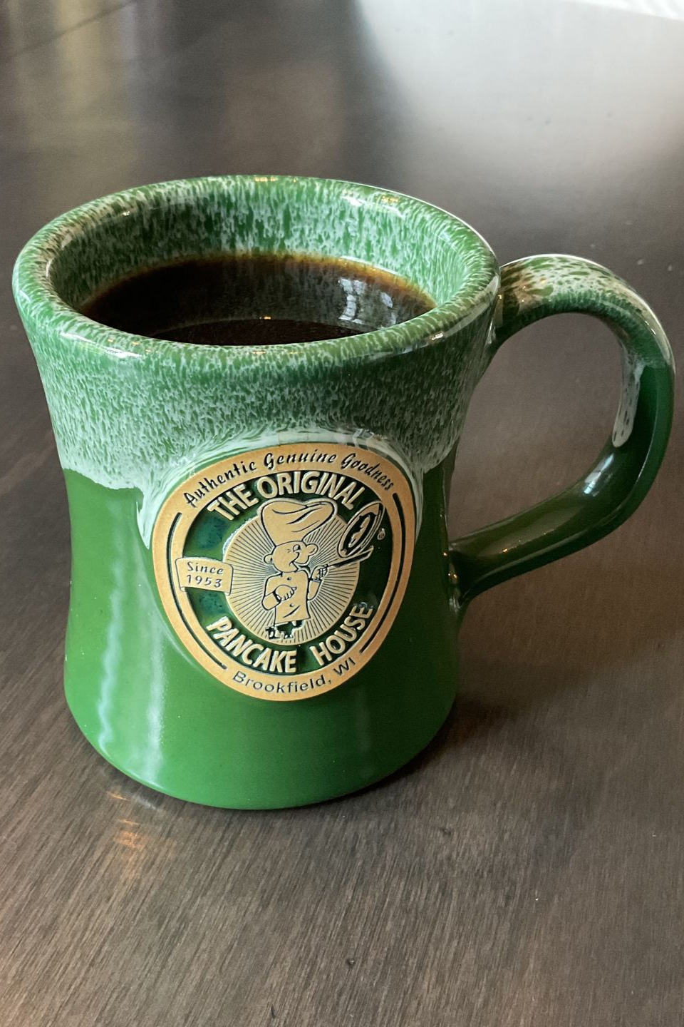 Green mug of coffee with 