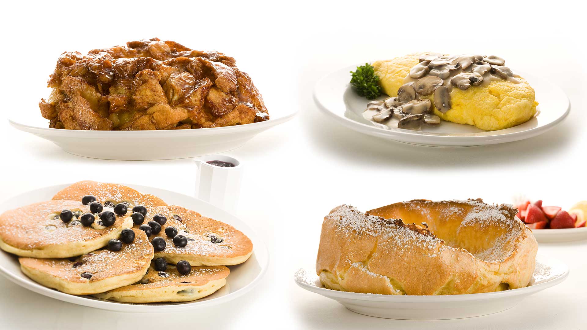 Breakfast dishes: bread pudding, omelet with mushrooms, blueberry pancakes, and Dutch baby.