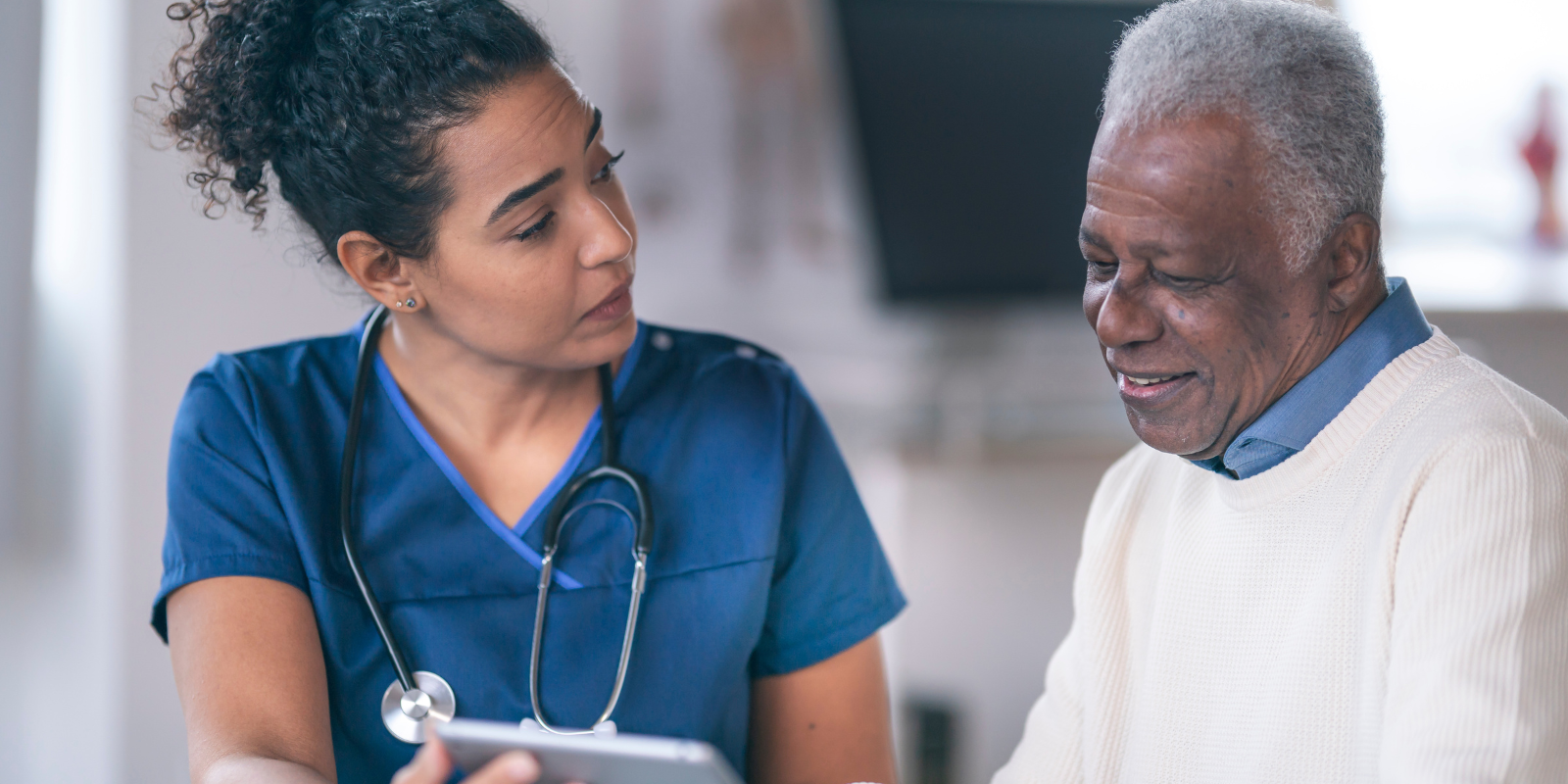 DPC provider discussing health share options with patient in white sweater