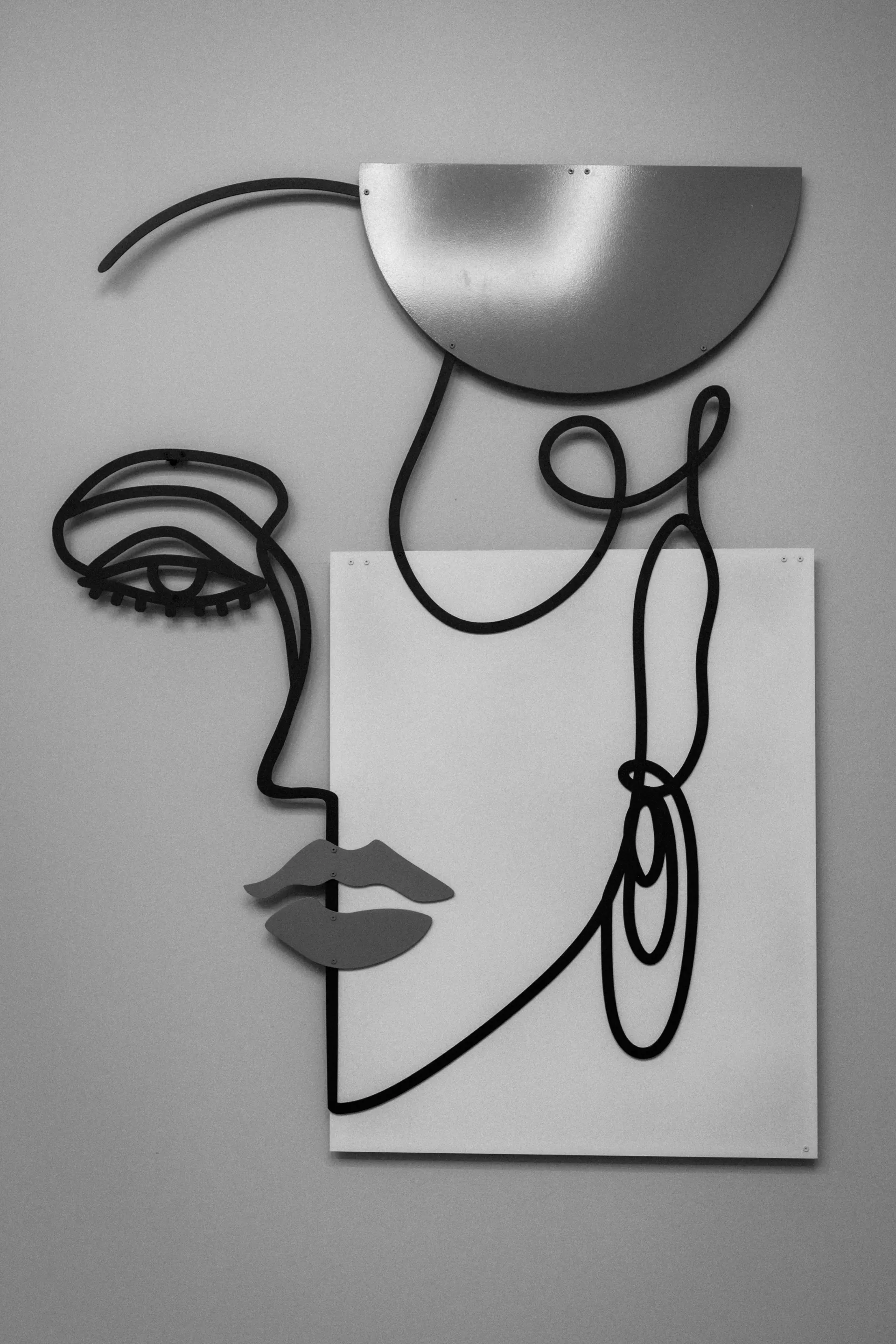 Abstract line-art face with black and gray curves on a white background