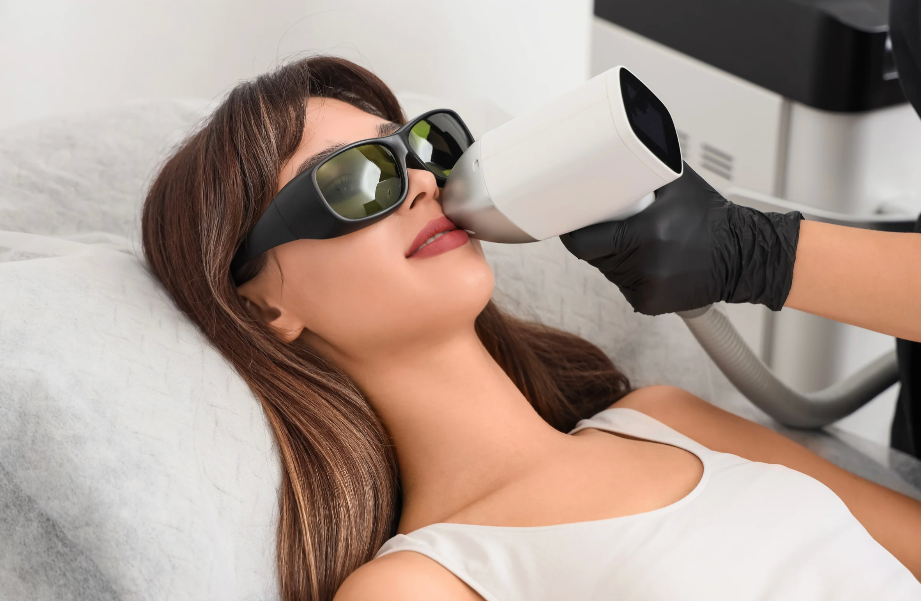 women sits in med spa receiving treatment