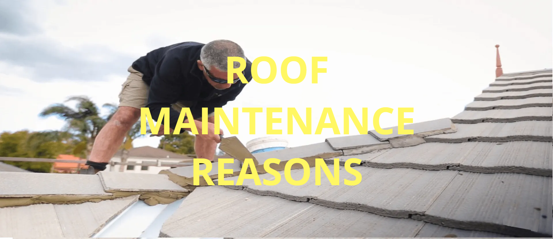 a man is working on a tiled roof restoration with a trowel