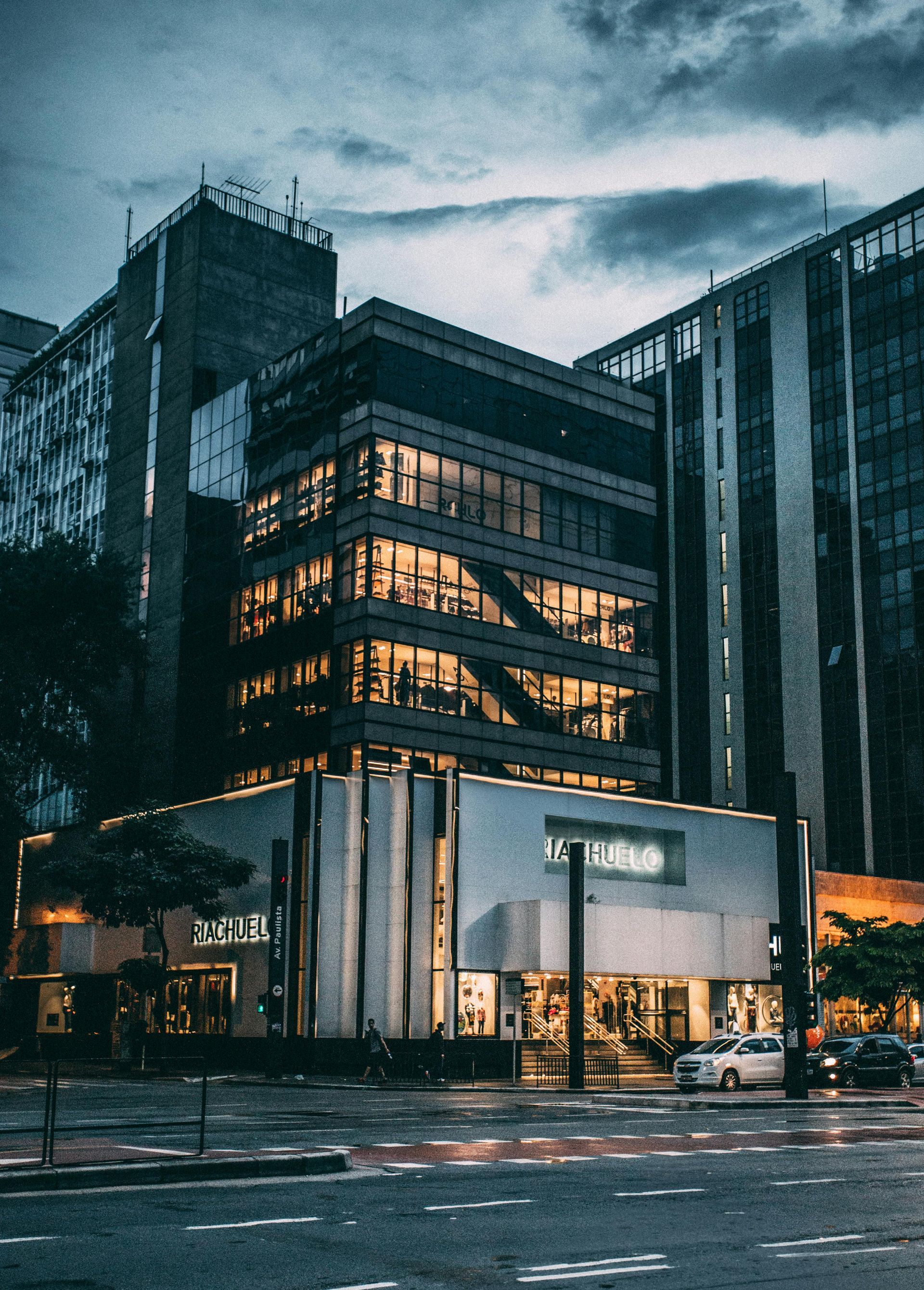 A large building with a lot of windows is lit up at night