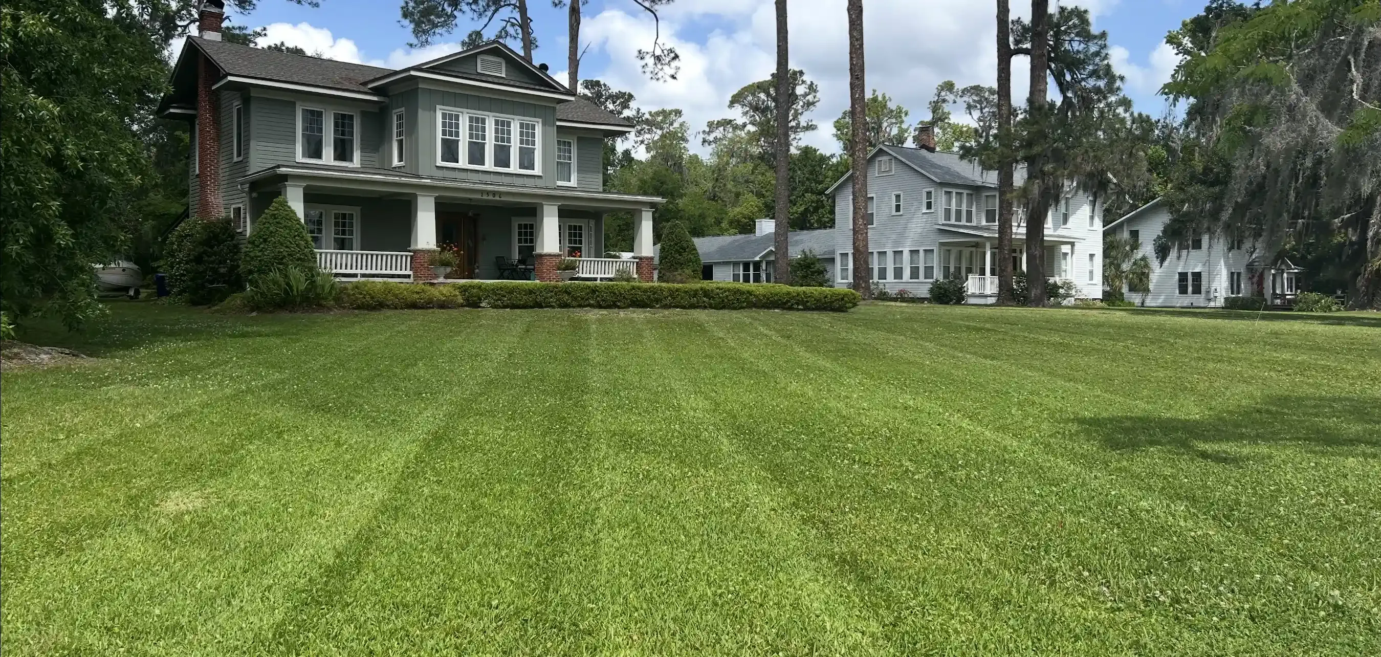 A large house with a large lawn in front of it.