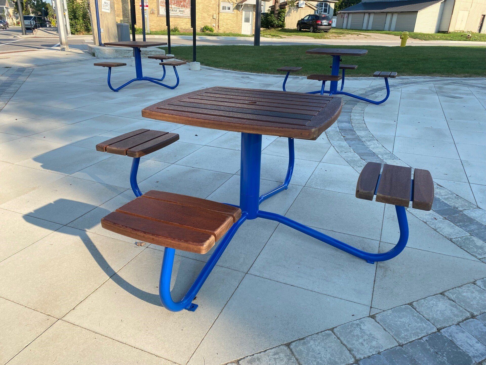 Blue picnic tables in the new Clifford Rotary Celebration Square