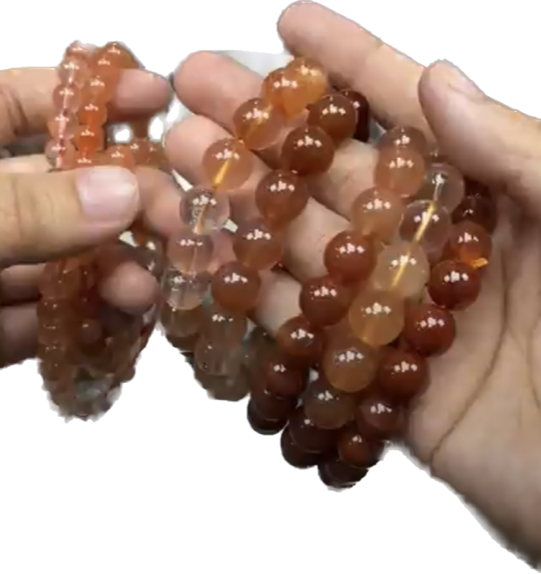 A person is holding a string of beads in their hands