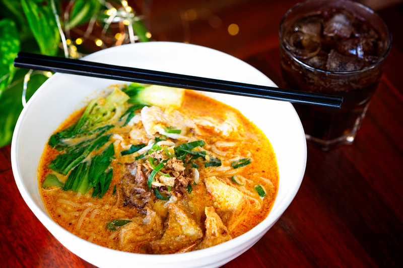 Creamy curry noodle soup with crispy toppings