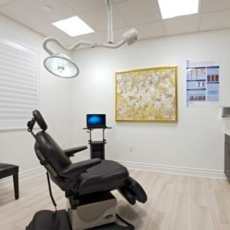 An operating room with a chair and a laptop