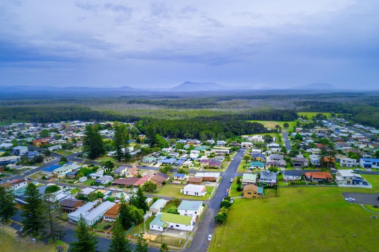 An Aerial View of a Residential Area With a Mountain in the Background — Headlands Glass in Goonellabah, NSW