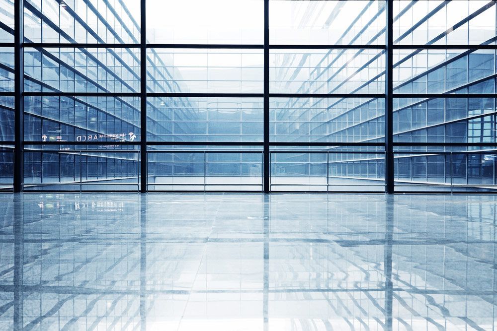 A Large Empty Room With Lots Of Windows And A Shiny Floor — Headlands Glass in Wardell, NSW