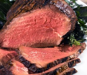 A close up of a piece of roast beef on a plate.