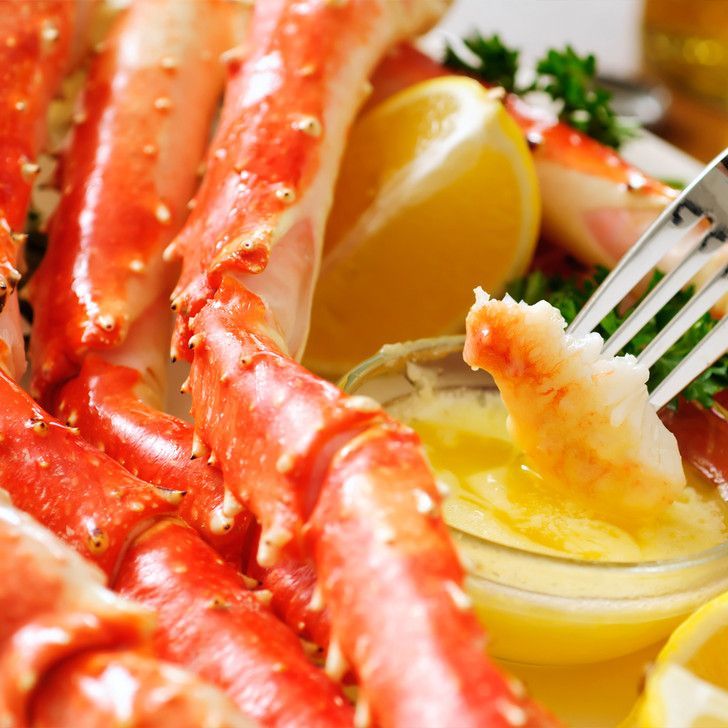 A close up of a crab with a fork in it