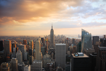 An aerial view of the new york city skyline at sunset.