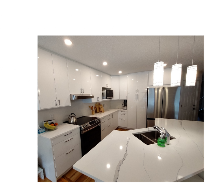 A kitchen with white cabinets , stainless steel appliances , a sink , and a stove.