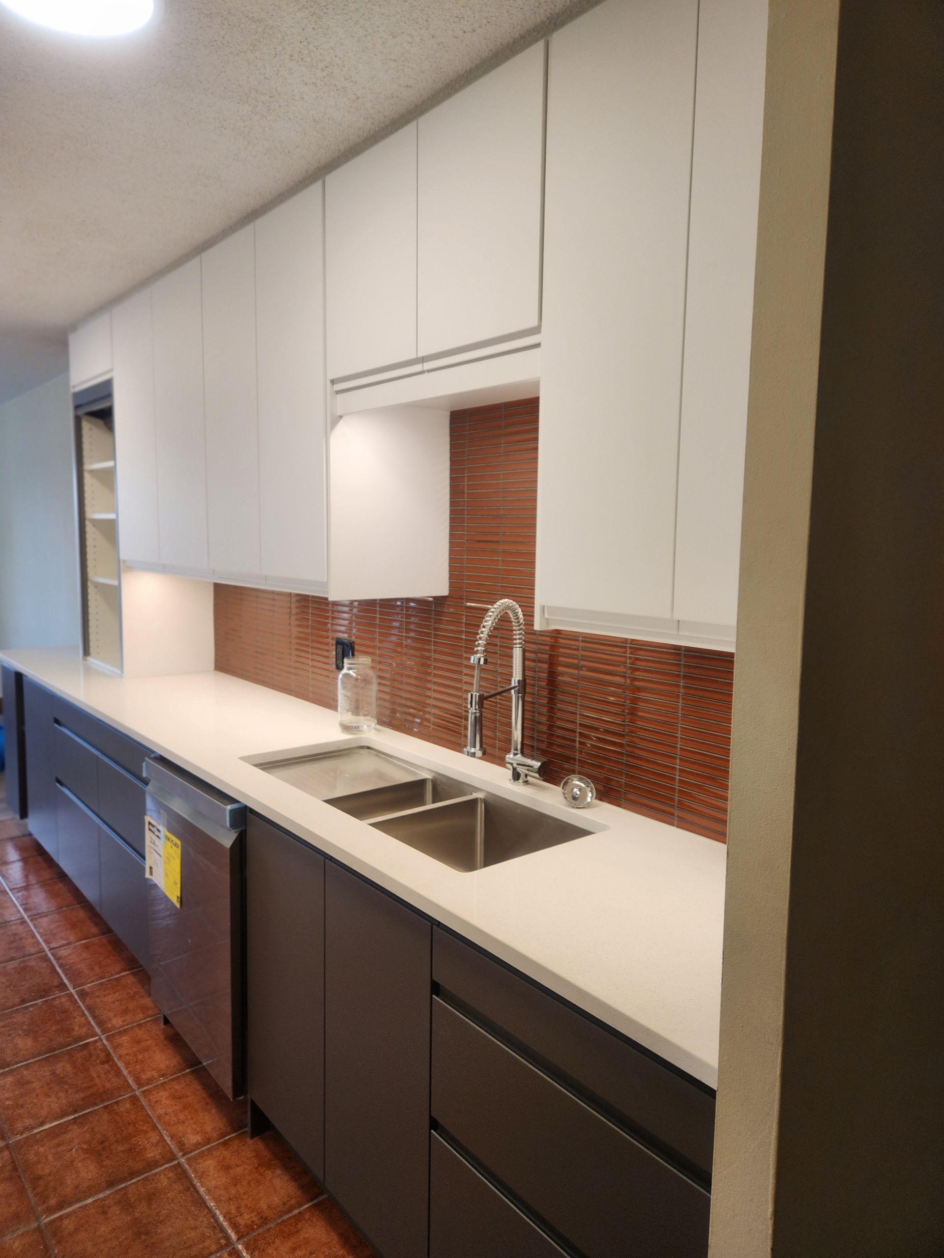 A kitchen with two sinks and a dishwasher