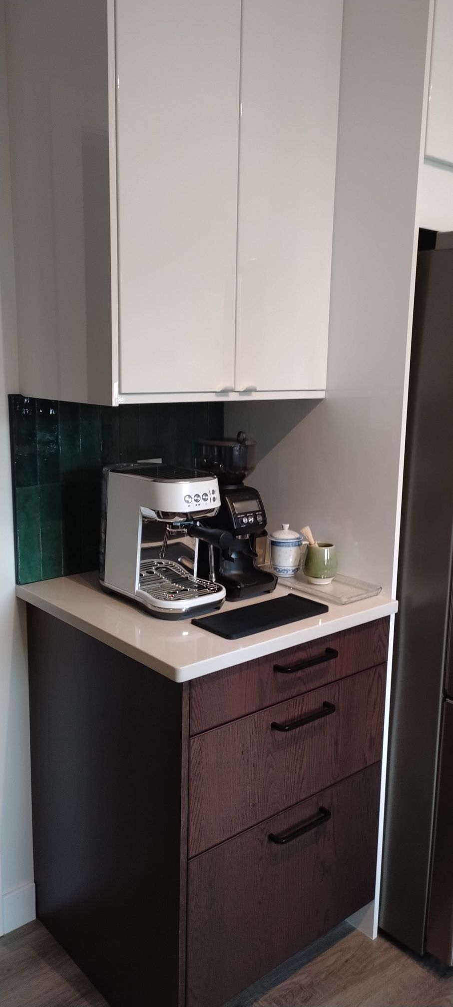 A coffee maker is sitting on top of a counter in a kitchen.