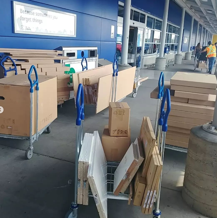 A cart full of boxes with one that says ' sale ' on it