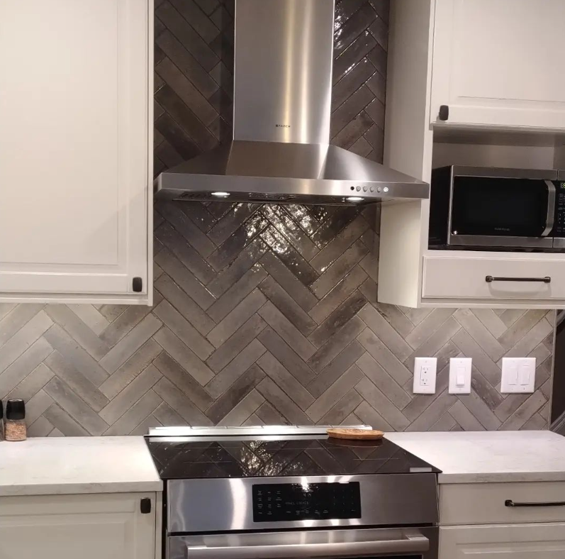 A kitchen with stainless steel appliances and white cabinets