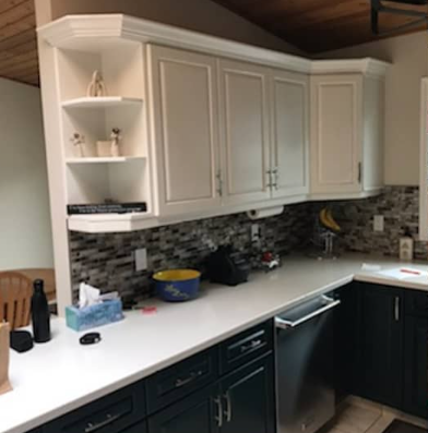 A kitchen with blue cabinets and white cabinets and a dishwasher