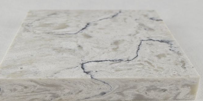 A close up of a white marble counter top on a white surface.