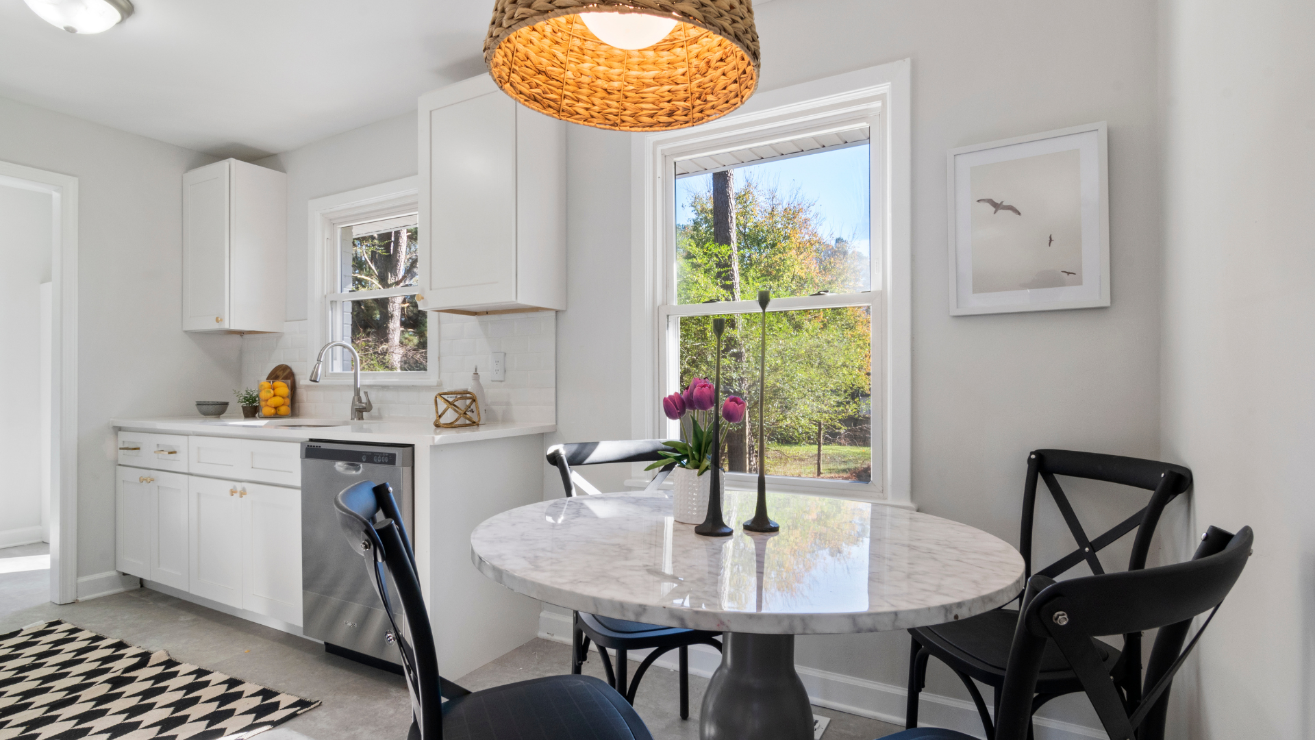 A kitchen with a table and chairs and a window.