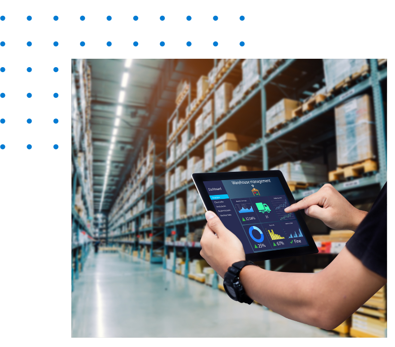 A person is using a tablet in a warehouse.