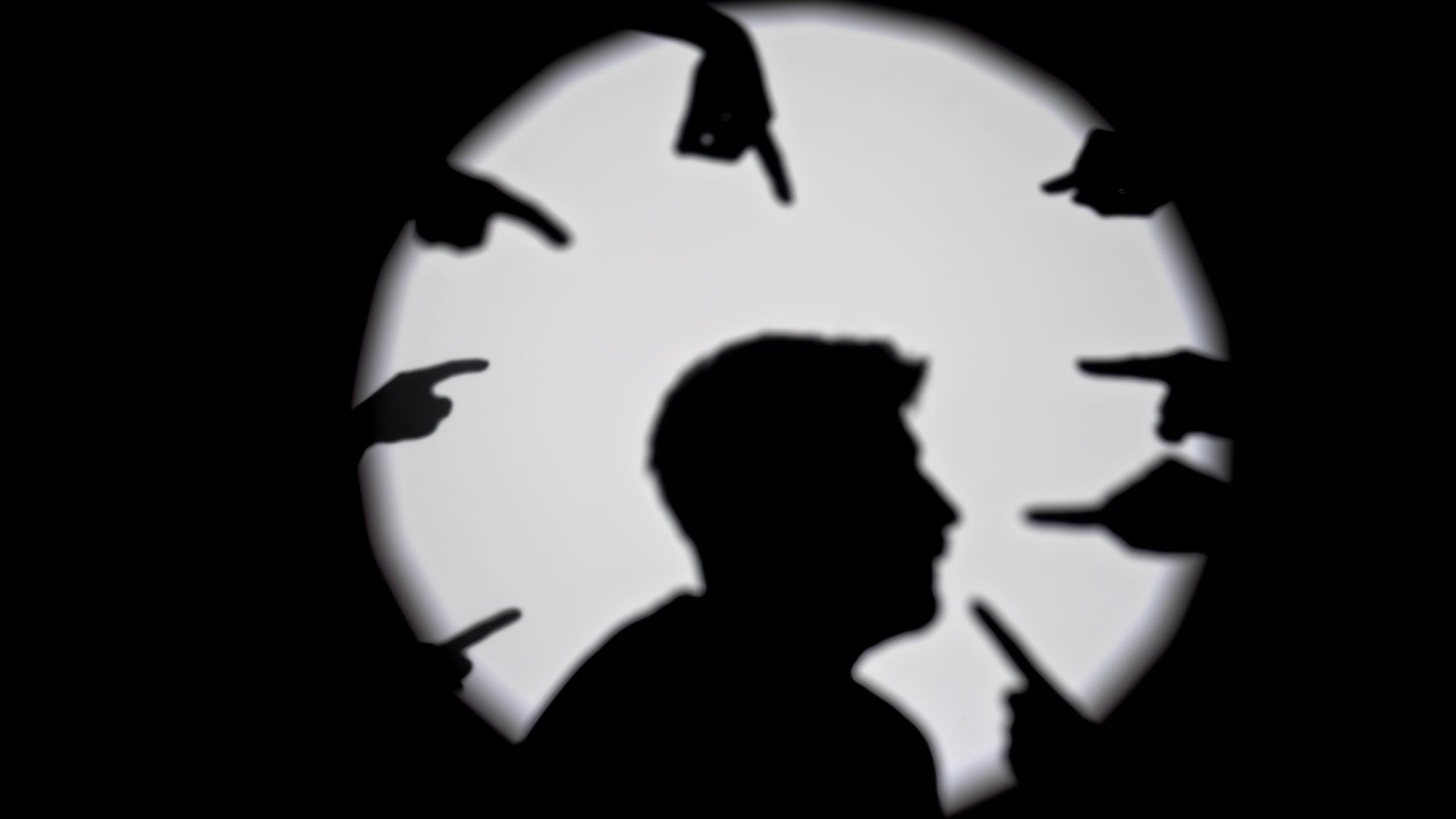 Silhouette of a person in profile against a bright circular light, with birds flying overhead.