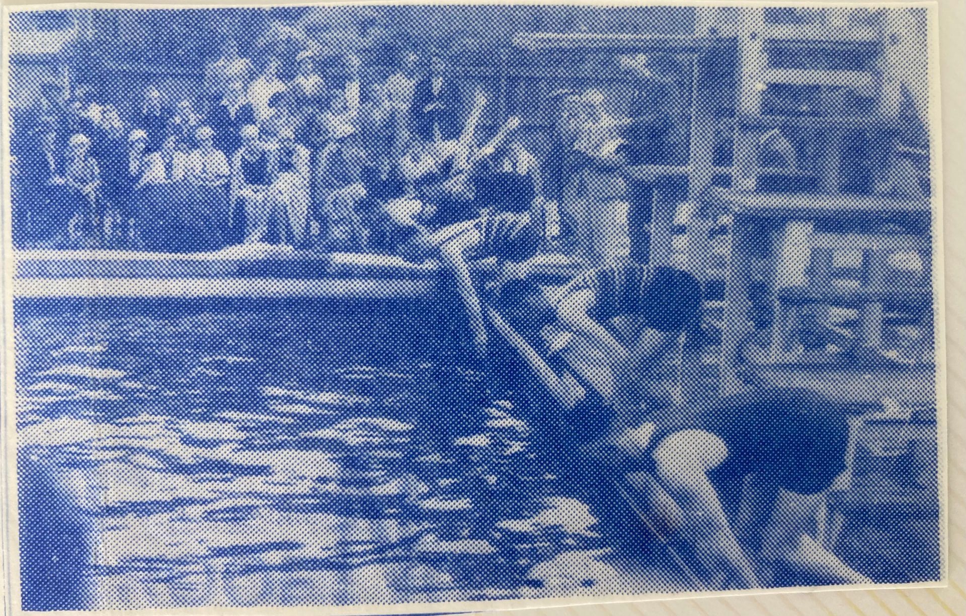 A blue and white photo of a boat in the water