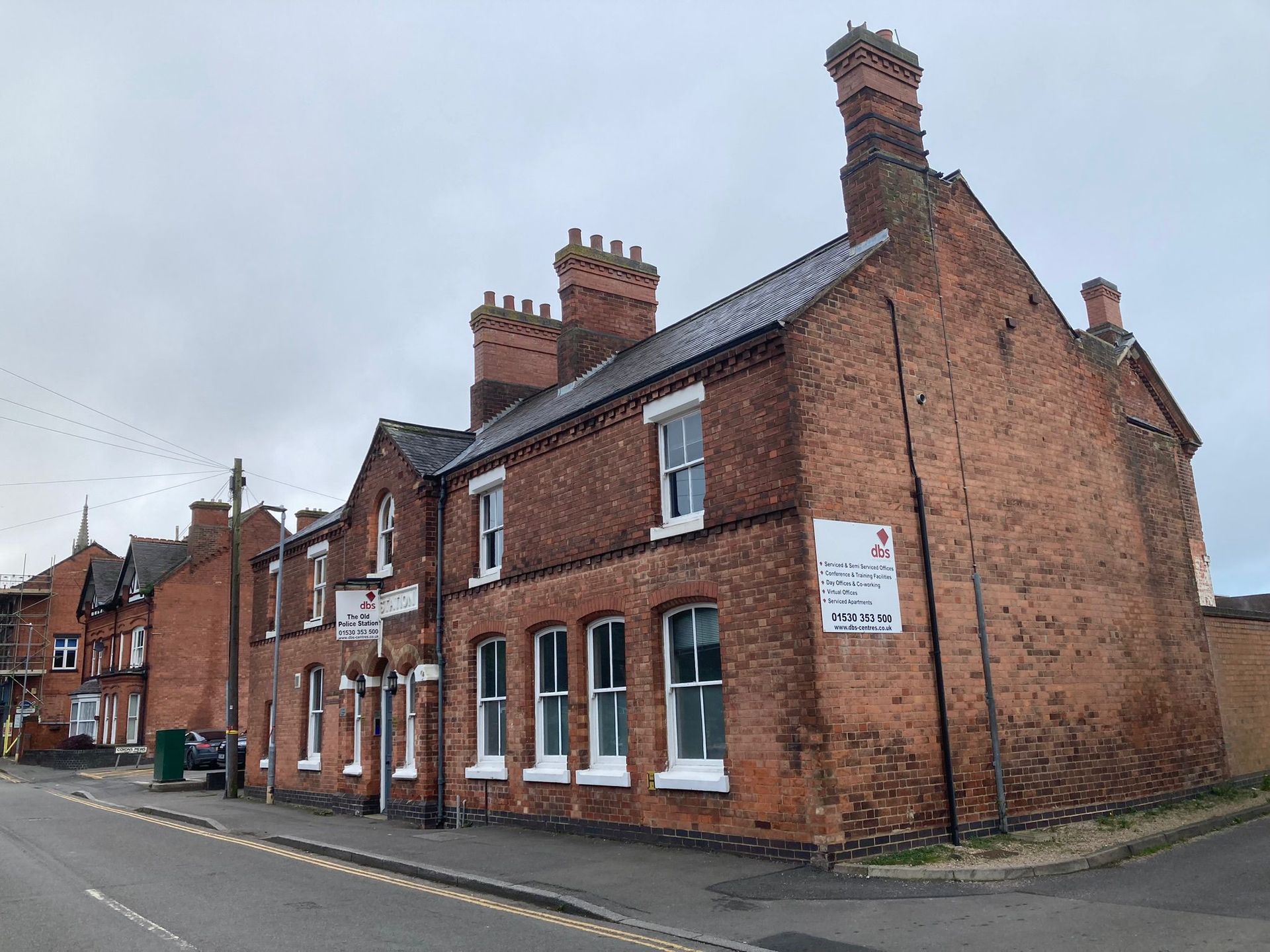 A row of brick buildings on the corner of a street.