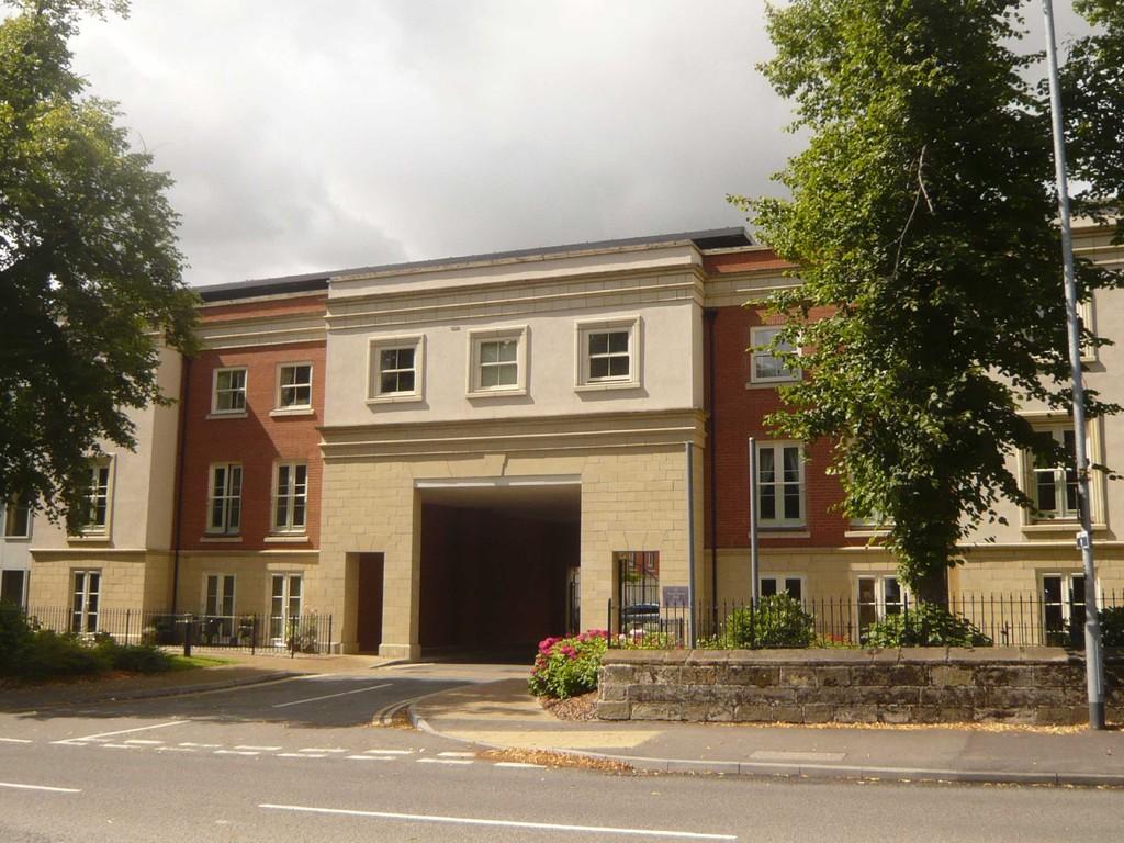 A large building with a lot of windows and trees in front of it