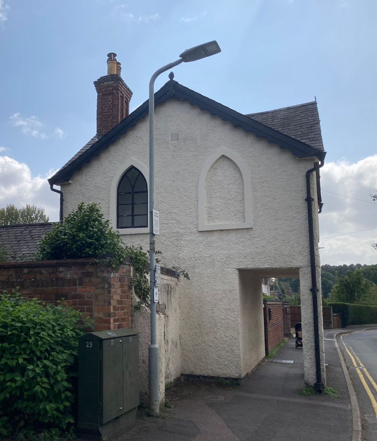 A small white building with a chimney on top of it of the Priest House 2024.