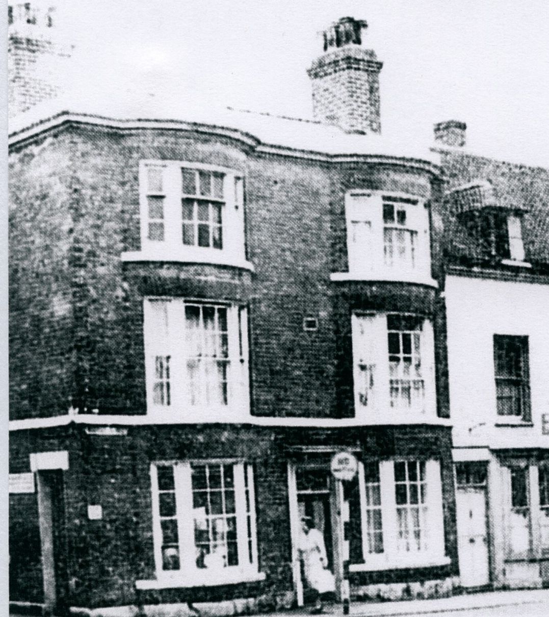 A black and white photo of a brick building