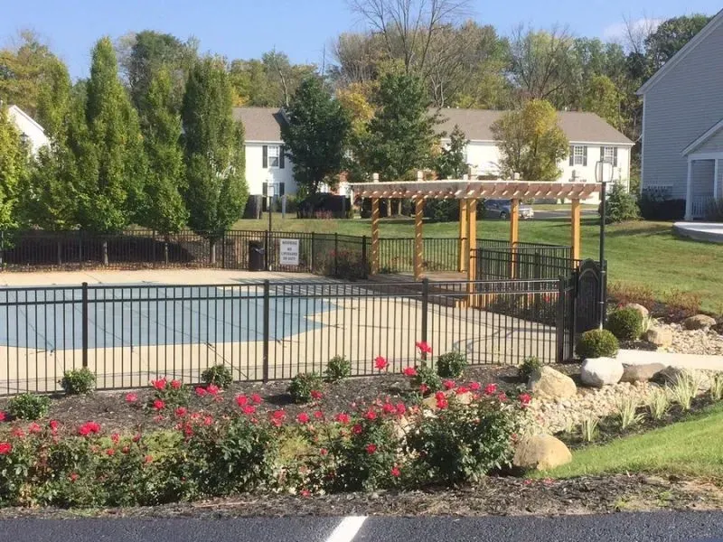 A aluminum fence surrounds a swimming pool in a residential area in Columbus