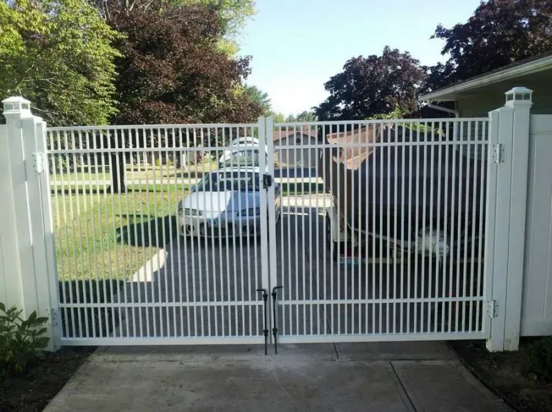 A white aluminum gate with a car parked behind it in Columbus