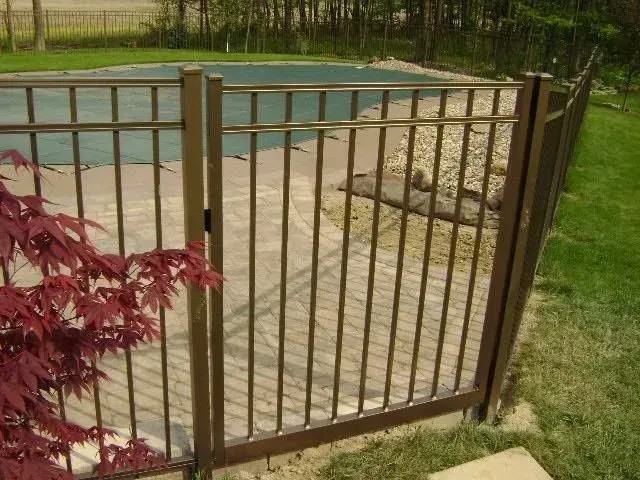A aluminum fence surrounds a swimming pool in a backyard in Columbus