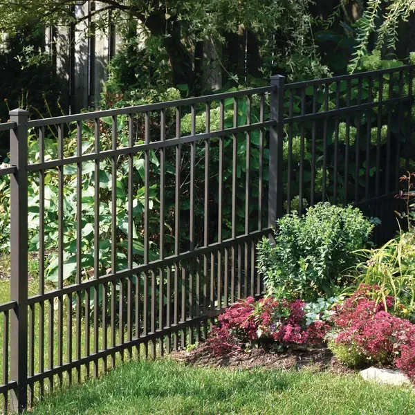 A aluminum fence surrounds a garden with flowers and trees in Columbus