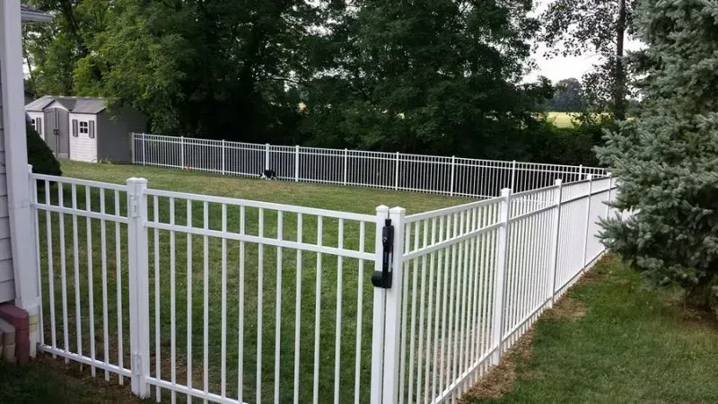 A white aluminum fence surrounds a lush green yard in Columbus