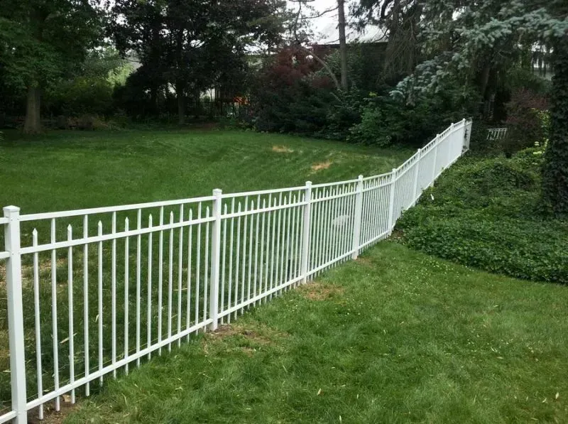 A white aluminum fence surrounds a lush green yard in Columbus